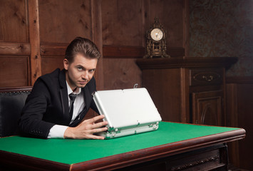 attractive young man opens the suitcase