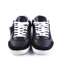 Black sneakers with white laces.