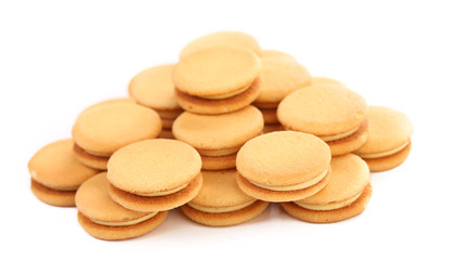 Bunch of sandwich biscuits with white cream.