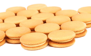 Bunch of sandwich biscuits with white cream.