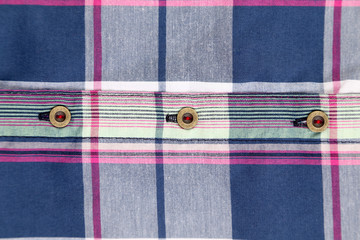 Close up of multi-colored plaid shirt.