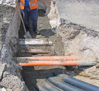 laying of optical fiber and electric cables in a roadworks worke