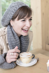 young beautiful woman sitting at the bar