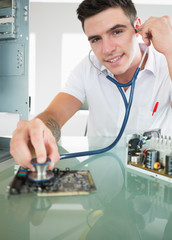 Handsome joyful computer engineer holding stethoscope