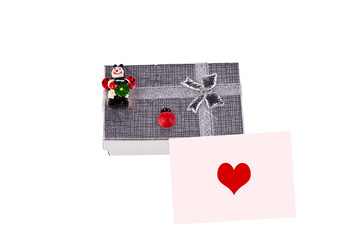 gift box with ladybugs and pink postcard with heart