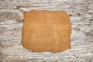 Piece of leather on the old wood