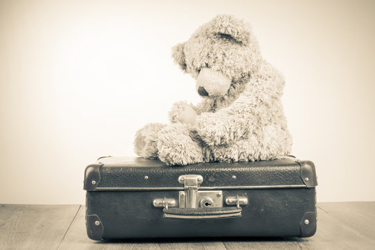 Teddy Bear toy alone on suit case retro sepia photo
