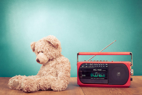 Retro toy Teddy Bear and radio recorder in front mint green