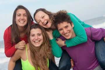 group of happy youth at the beach