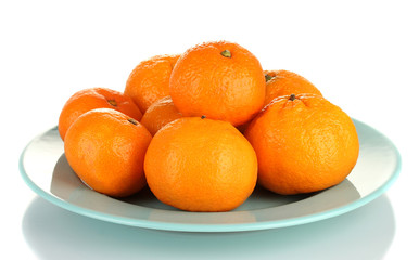 Tasty mandarines  on color plate isolated on white