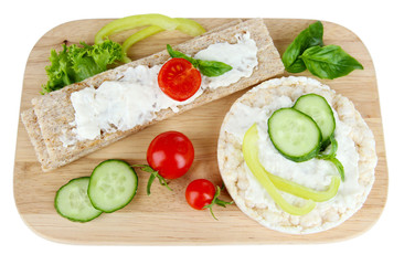 Tasty crispbreads with vegetables, isolated on white