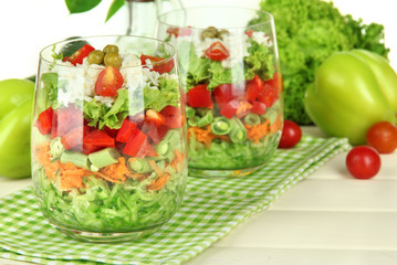 Tasty salad with fresh vegetables on wooden table
