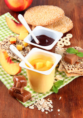 Tasty   cream desserts with pieces of fresh fruits, cookies and
