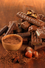 Delicious chocolate bars with cocoa and nuts close up