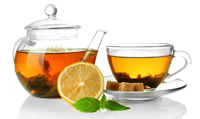 Cup and teapot of green tea with lemon and sugar isolated