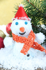 Beautiful snowman and Christmas decor, on golden background