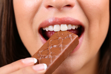 Closeup of woman eating chocolate