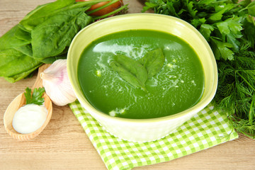 Tasty spinach soup, on wooden table