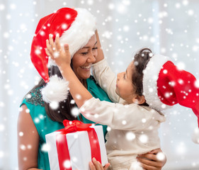 happy mother and child girl with gift box