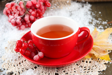 Still life with viburnum  tea in cup, berries and snow,