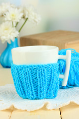 Cup with knitted thing on it close up