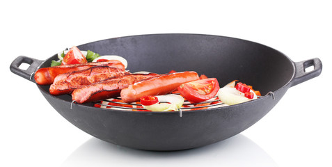 Delicious sausages in wok isolated on white