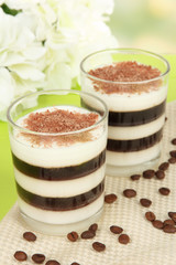 Tasty jelly coffee with milk on table on light background