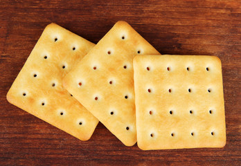 Delicious crackers on wooden background