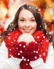 woman in scarf and mittens with christmas ball