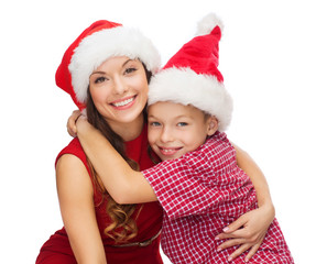 happy mother and child boy in santa helper hats