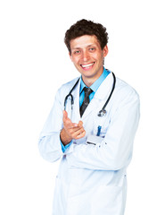 Fototapeta premium Portrait of a smiling male doctor showing finger at you on white