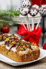 Fruitcake with dried fruits and nuts in christmas setting