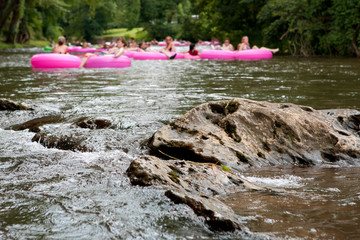 Defocused People Tubing Down River Approach Boulder In Focus © blueiz60