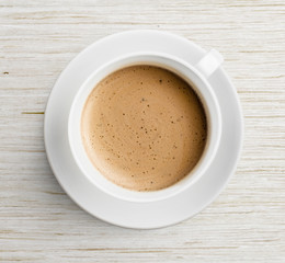 coffee cup with foam  on table top view - obrazy, fototapety, plakaty