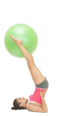 Fototapeta na wymiar Content sporty brunette holding exercise ball between legs