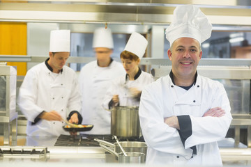 Mature male chef posing with crossed arms