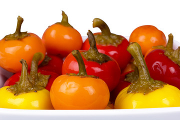 a lot of round hot peppers of different colors