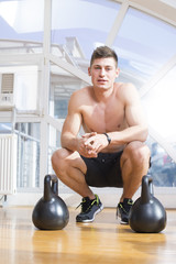 Man in a gym with dumbbells