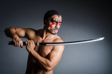 Man with sword and face paint © Elnur