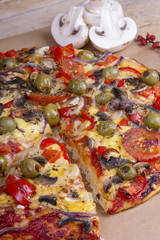 homemade pizza with olives, mushrooms and paprika