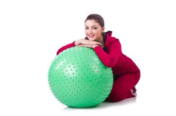 Young woman with ball exercising on whitee