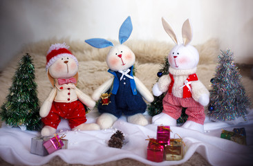 Christmas toy rabbits on the background trees