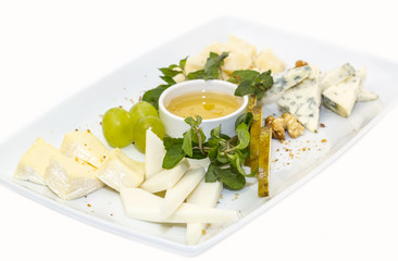 cheese plate, with several kinds of cheese on a white background