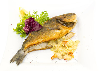 Fried fish dorado with vegetables and lemon