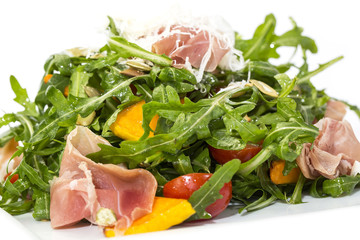 salad of arugula ham cheese on a white background