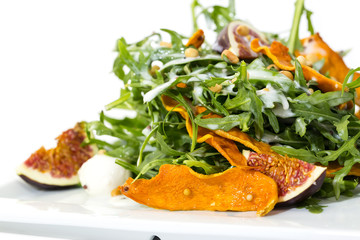 salad of arugula figs and cheese on white background