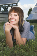 smiling woman between photovoltaics