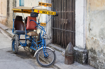 Street in Havana with an  old bicycle and shabby buildings
