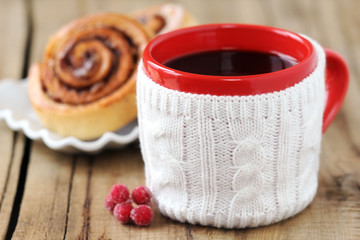 Christmas coffee with cinnamon rolls on wooden background