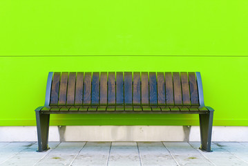 Stylish bench against green wall